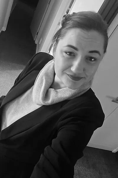 Annelize in the office, in a navy blazer